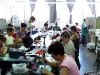 Lipirea manuală a unor pietre pe diverse produse textile la Jolidon, în cadrul Cluj Brands Tour 2011