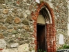 Fațada cu pietre romane și pictură medievală a bisericii din Sînpetru